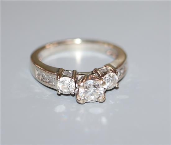 A 14k white gold and diamond dress ring, the central stone approximately 0.50cts, flanked by two 0.15ct stones